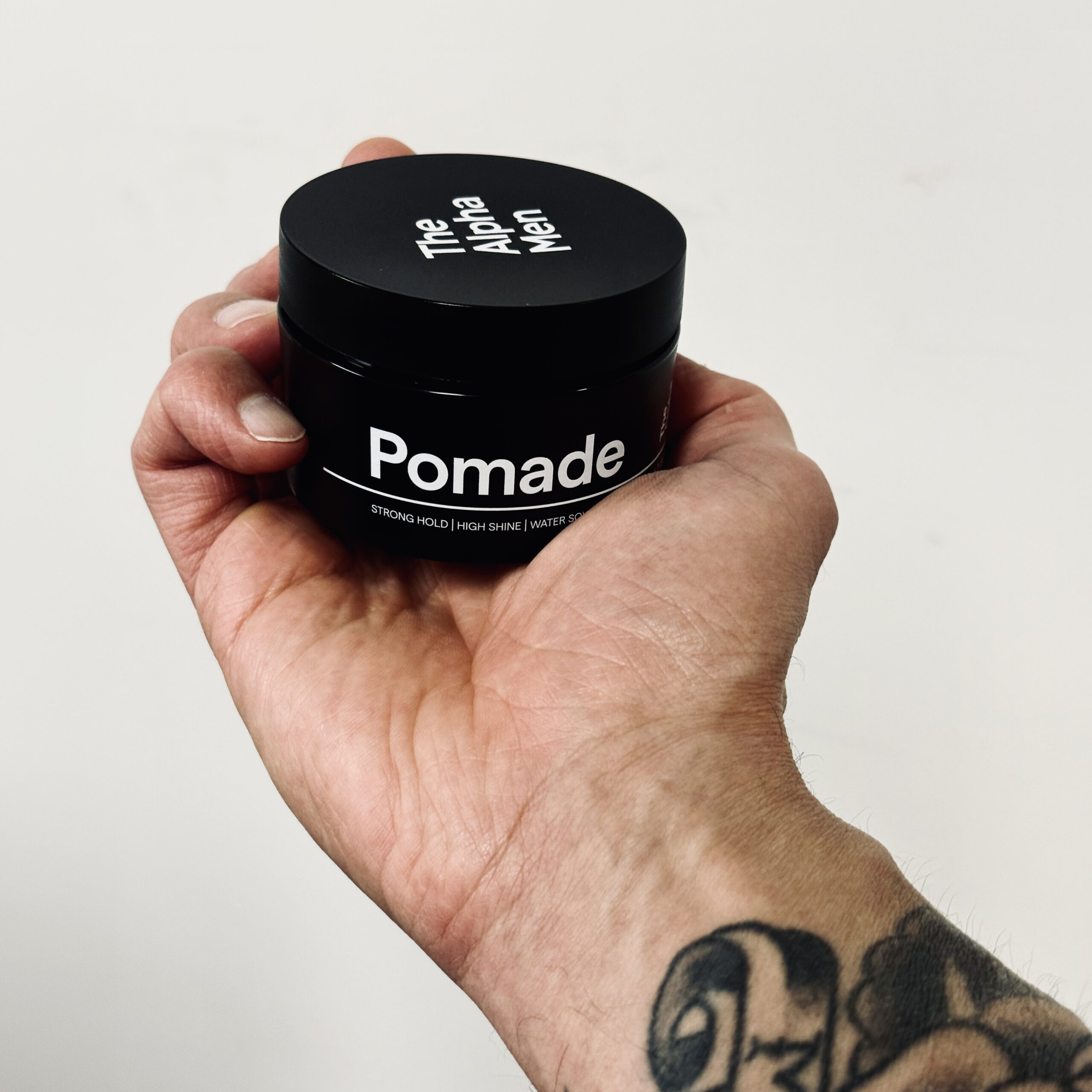 The Alpha Men Pomade in hand